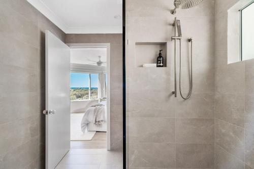 a shower with a glass door in a bathroom at A Perfect Stay - Byron Pacific Vista in Byron Bay