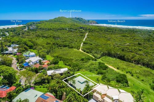 an aerial view of a house on a hill next to the ocean at Cape Breeze - 5 BR home with headland views in Byron Bay