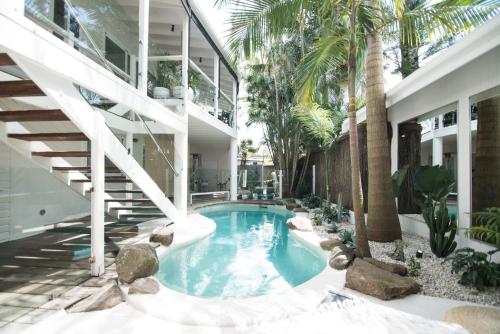 a swimming pool in the middle of a building at A Perfect Stay - Cactus Rose Villa in Byron Bay