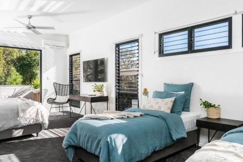 a bedroom with a bed with a blue blanket at A Perfect Stay - Catalinas in Byron Bay