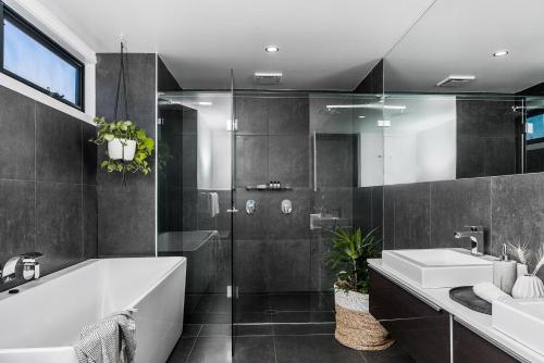 a bathroom with a tub and a sink at A Perfect Stay - Catalinas in Byron Bay