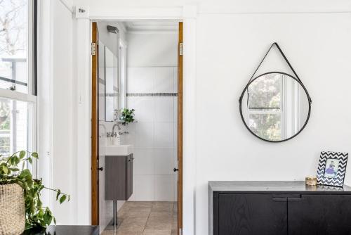 a bathroom with a sink and a mirror on the wall at A Perfect Stay - Charlottes Web in Bangalow