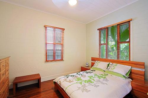 a bedroom with a bed and two windows at A Perfect Stay - Harkaway in Byron Bay