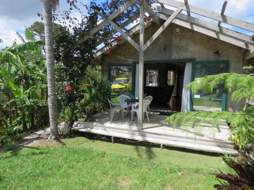 a porch of a house with a table and chairs at Mill Bay Charmer in Mangonui