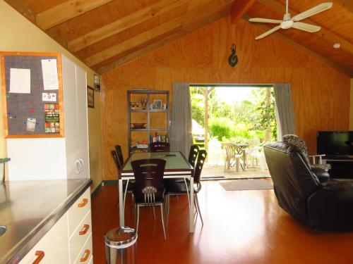 a kitchen with a table and chairs and a dining room at Mill Bay Charmer in Mangonui
