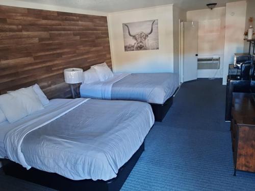 two beds in a hotel room next to a desk at Timber Ridge Lodge Gatlinburg in Gatlinburg