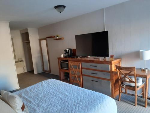 a bedroom with a bed and a desk with a television at Timber Ridge Lodge Gatlinburg in Gatlinburg