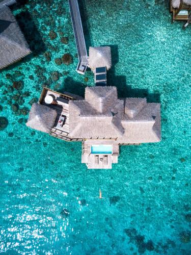 an aerial view of a house in the water at Conrad Bora Bora Nui in Bora Bora