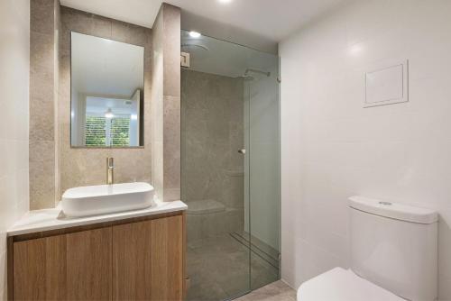 a bathroom with a toilet and a sink and a shower at A Perfect Stay - Pacific Blue in Byron Bay