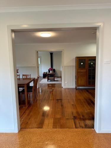 an empty living room with a table and a dining room at Two Twenty Two Farm Stay in Grassy