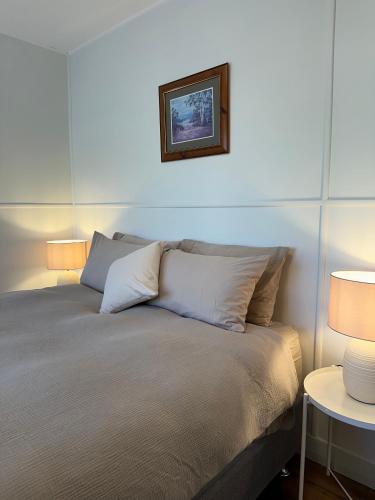 a bedroom with a bed with two lamps on it at Two Twenty Two Farm Stay in Grassy