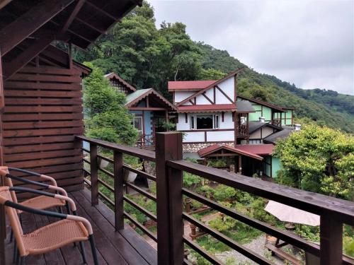 a balcony of a house with chairs on it at Shiyai Taoyuan in Renai