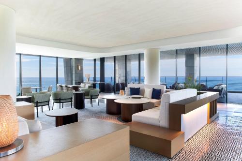 a hotel lobby with a view of the ocean at Parnas Hotel Jeju in Seogwipo
