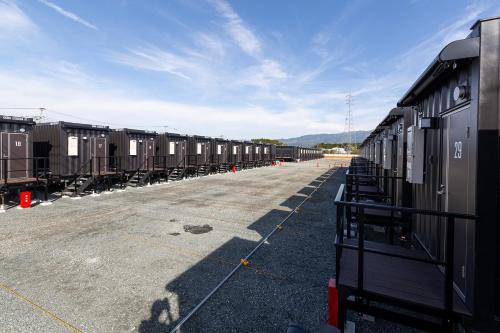 a row of train cars parked in a parking lot at HOTEL R9 The Yard Kikuchikyokushiisaka in Sugimizu