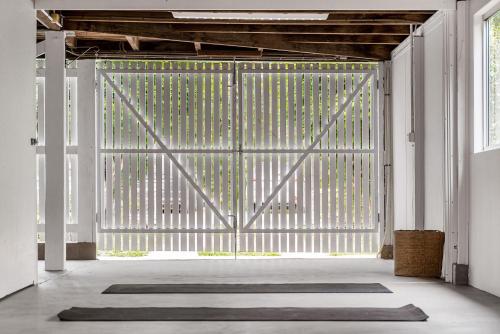 an open gate with a rug in front of it at Mullum River House - waterfront heritage home in Mullumbimby