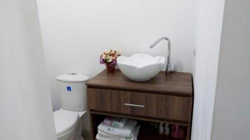 a bathroom with a sink and a toilet at VILLA MORELI in Papare