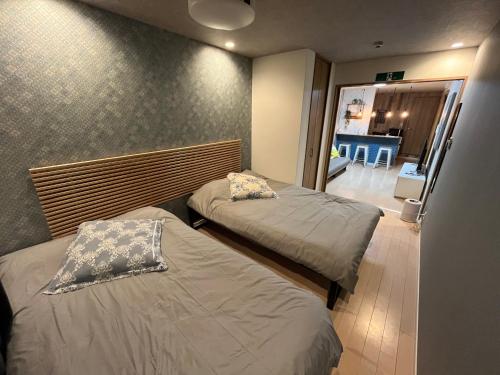 大阪市にある京セラドーム大正駅徒歩3分 観光に便利 CityMaisonDomeFrontの廊下付きの小さな部屋のベッド2台