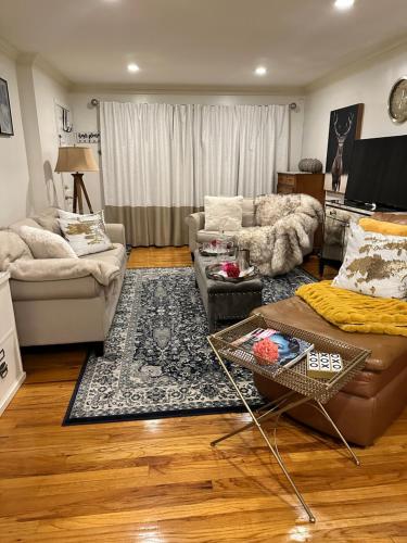 a living room with a couch and a table at Welcoming Private Suite with French Touches in Union