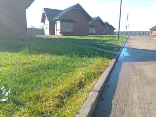 a street with a grass field and a house at Cabañas Loteo Monaco, Angol in Angol