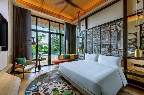 a bedroom with a large bed and a living room at Artyzen Singapore in Singapore