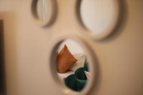 a reflection of a bed with pillows in a mirror at El Hogar II in Kiambu
