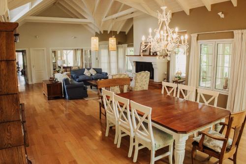 a dining room and living room with a table and chairs at La Aguada Hotel Boutique in San Rafael