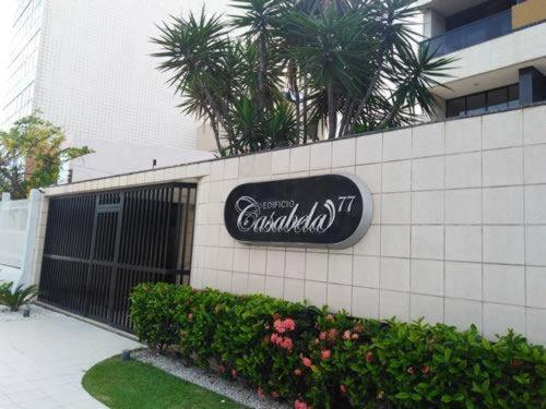 a building with a sign on the side of it at Apartamento em Maceió com beira mar in Maceió