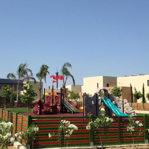 a playground in a park with a slide at Astir Odysseus Kos Resort and Spa in Tigaki
