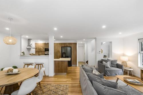 a living room with a couch and a table at Drift - 3 BR home near town & beach with pool in Byron Bay
