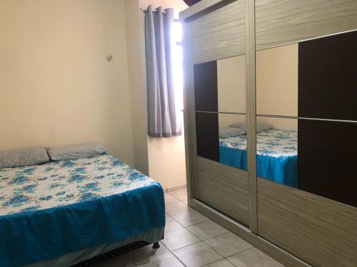 a bedroom with a bed and a dresser at Quarto privativo in Campina Grande