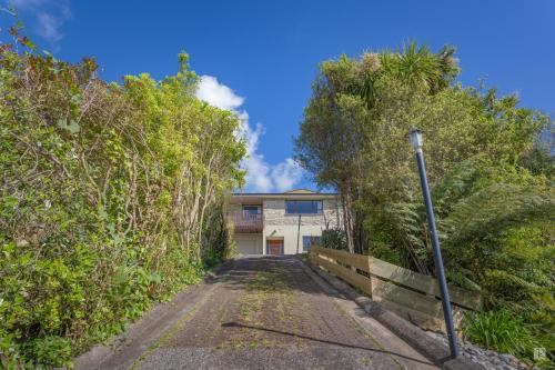 an empty driveway to a house with trees at Spacious with fabulous views overlooking the city in Hamilton