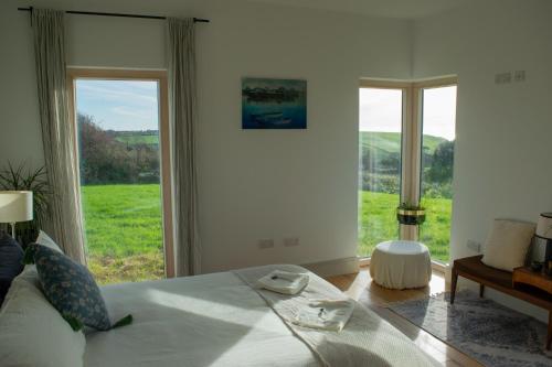 a bedroom with a bed and a large window at Cedarblue in Ballyvoyle Cross Roads