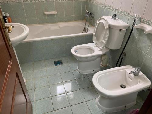 a bathroom with a toilet and a bidet at AlAIN GUEST HOUSE in Al Ain