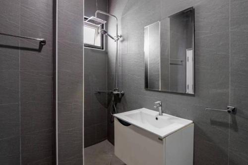 a bathroom with a sink and a shower with a mirror at Luxury Thai Style Pool Villa in downtown Pattaya, close to Walking Street in Pattaya South