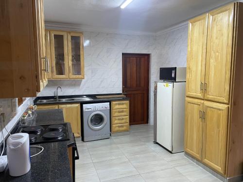 a kitchen with a refrigerator and a washing machine at Golfview Lodge in De Deur