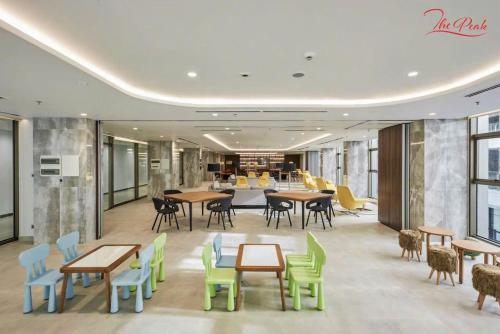a lobby with tables and chairs and a cafeteria at Midtown Premium Phu My Hung in Ho Chi Minh City