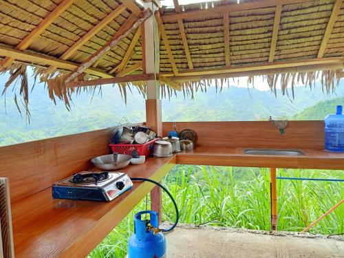a kitchen with a counter with a view of a mountain at MIRA AgroPark in Kuyambay
