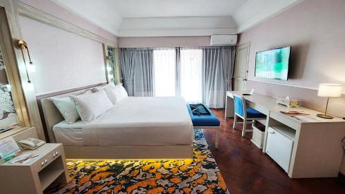 a hotel room with a bed and a desk at Jatinangor National Golf & Resort in Jatinangor