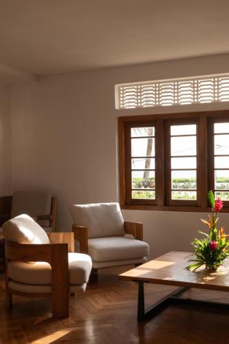 a living room with a chair and a coffee table at The Charleston in Galle