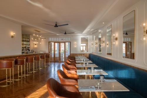 a restaurant with a row of tables and chairs at The Charleston in Galle