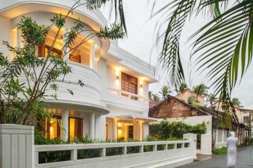 a large white house with trees in front of it at The Charleston in Galle