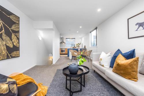a living room with a couch and a table at 3 BDR CBD Get Away in Auckland
