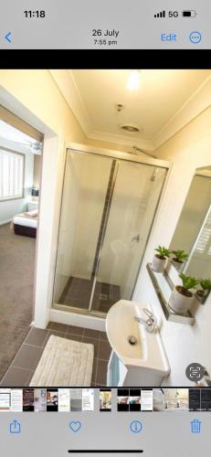 a bathroom with a white sink and a shower at STUDIO IN BONDI in Sydney