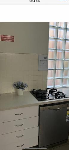 a kitchen with a stove and a counter top at STUDIO IN BONDI in Sydney