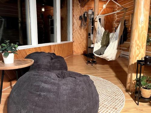 a large bean bag chair on a porch with a hammock at 7 Acres Forest - Skiing Close - Privacy - Theatre in Golden