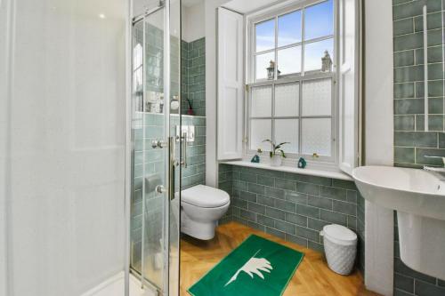 a bathroom with a toilet and a sink and a shower at Seaside Luxury Escape in Aberdour