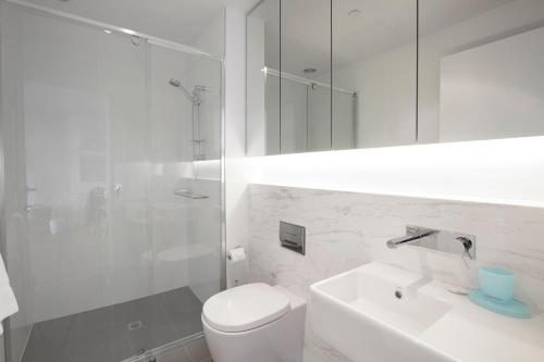 a bathroom with a toilet and a sink and a shower at Boutique Stays - Sea Breeze at Port in Melbourne