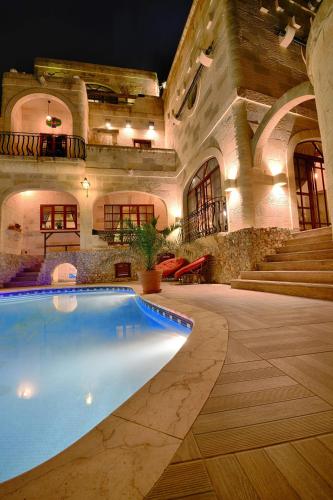 an indoor swimming pool in a building with a house at Renovated Farmhouse with Pool, Jacuzzi, Gym in the Village Centre in Nadur