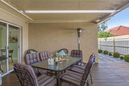a patio with a table and chairs on a deck at Boutique Stays - The Richardson in Mentone