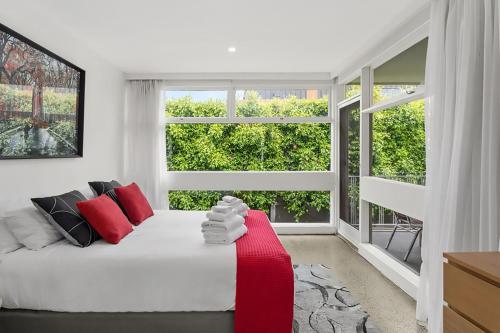 a living room with a white couch and a window at Boutique Stays - Brighton By Sea in Melbourne